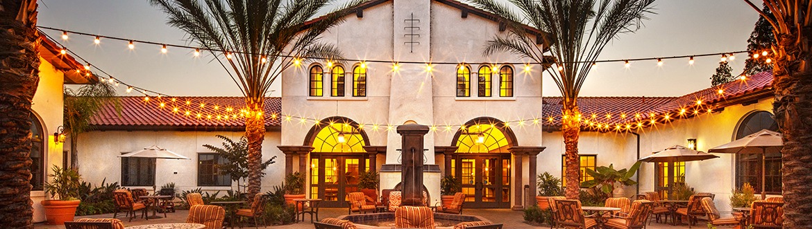 Exterior patio of community at dusk with string lights