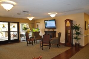 Room with chairs around fireplace and tv