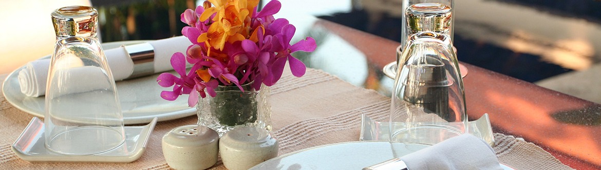 Table with dinner plates and flowers