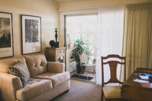 Living room with a beige couch and a desk